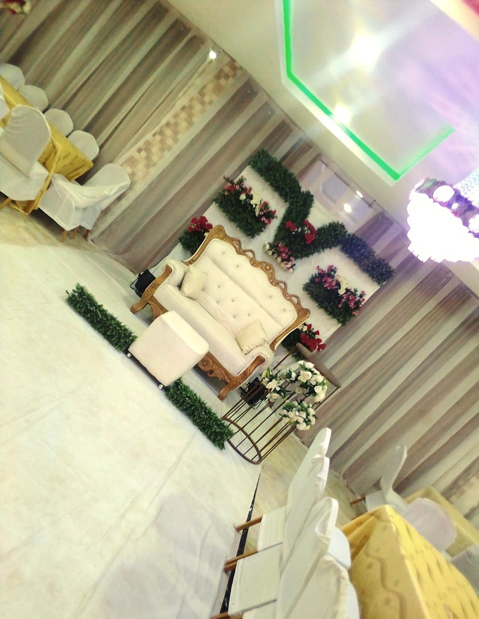 Bridal seating framed by greenery and florals